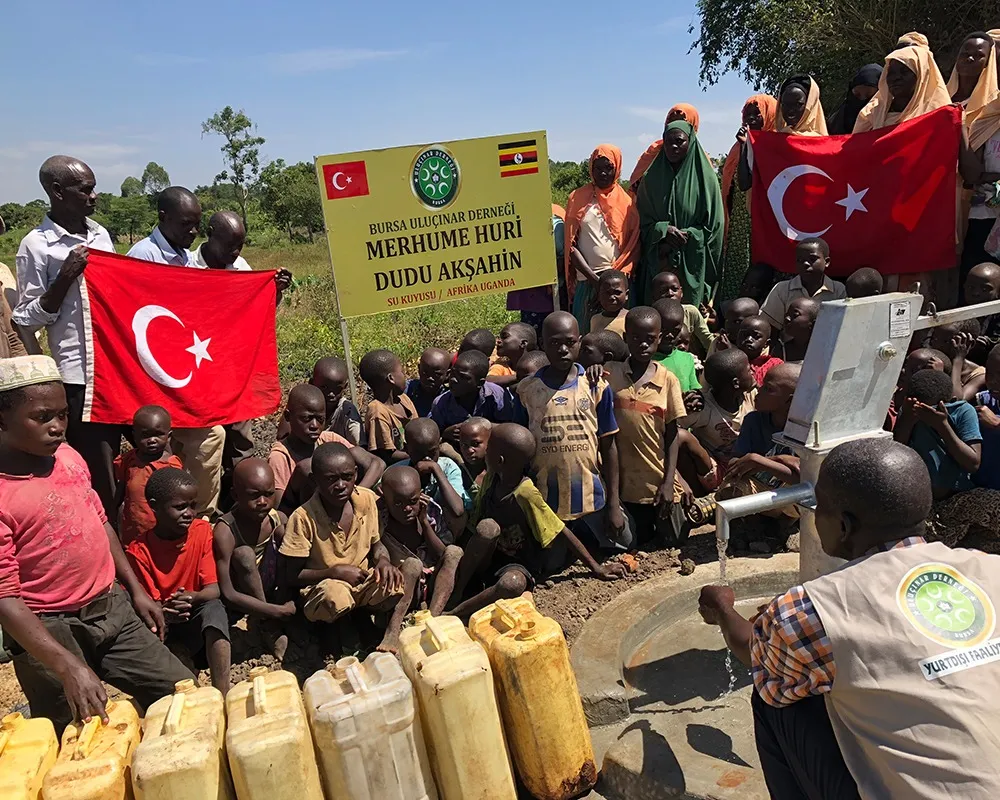 Açılan su kuyusunun başında bidonlarıyla bekleyen çocuklar
